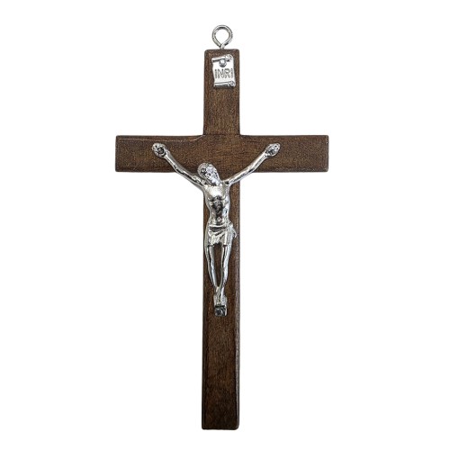 Traditional wooden wall cross 12 cm high in a dark walnut wood finish with a silver metal corpus of Jesus and a hanging loop at the top.