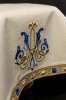 Monogram maryjny i zdobione obrzeże welonu ecru – detal